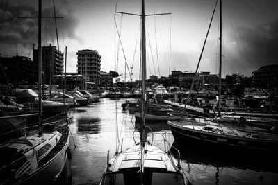 Boats in river with buildings in background