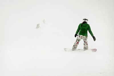 Person with umbrella on snow against mountain