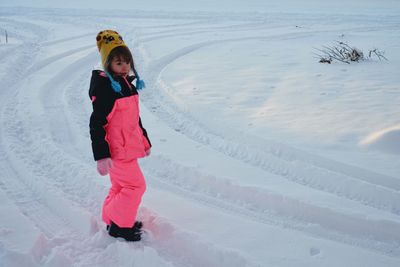 Full length of girl standing in snow