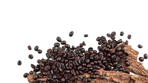 High angle view of coffee beans against white background