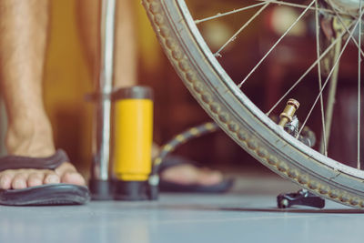 Close-up of man pumping bicycle wheel