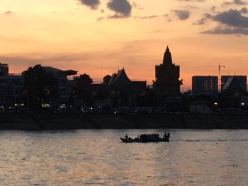 Scenic view of city against sky during sunset