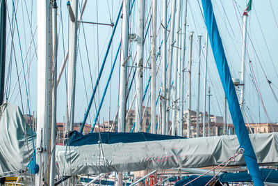 Sailboats moored against clear sky