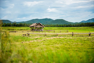 Built structure on field against sky