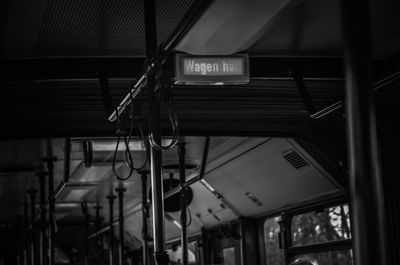 Low angle view of illuminated sign on ceiling