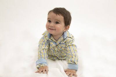 Portrait of smiling boy against white background