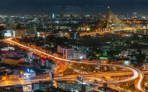 High angle view of illuminated rama viii bridge and cityscape at night