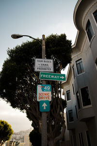 Low angle view of road sign against sky