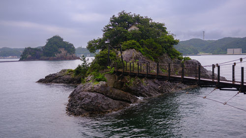 Scenic view of sea and island against sky