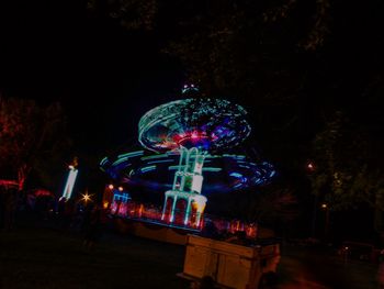 Illuminated ferris wheel at night