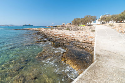 Scenic view of beach against clear blue sky