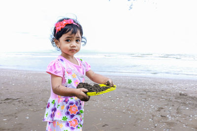 Cute girl standing on beach