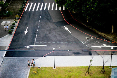 High angle view of people walking on road