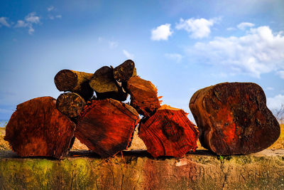 Stack of rocks on field against sky