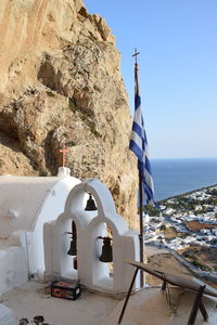 Traditional building by sea against sky