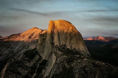 View of rock formation against cloudy sky