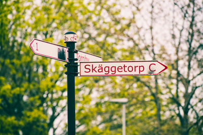 Low angle view of road signs against trees