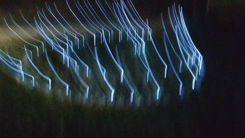 Close-up of light trails in sea at night