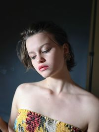Portrait of a beautiful young woman over black background