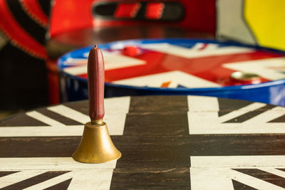 Close-up of bell over flag drawing on table