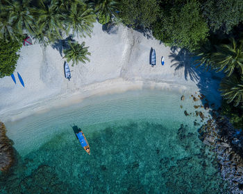 Tranquil aerial shot of beach scene. exotic tropical island resort, white sand and turqoise sea. 