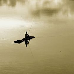 Young woman fishing in sea