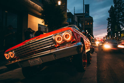 Cars on illuminated street at night