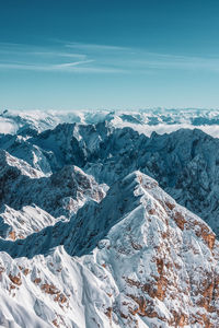 Aerial view of snowcapped mountains against sky