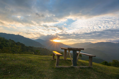 Scenic view of table and mountains against sky during sunset