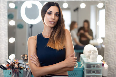 Portrait of confident fashion model standing in studio