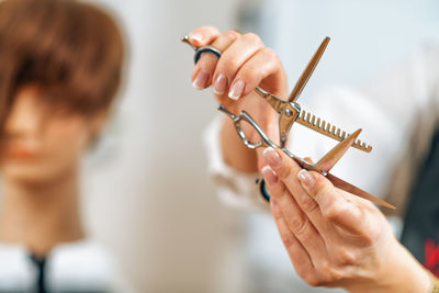 Hand of a hairdresser holding hairdressing scissors