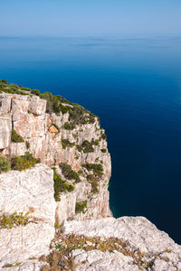Scenic view of sea against rocks