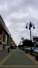 Street light in city against sky