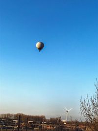 Low angle view of hot air balloon against blue sky