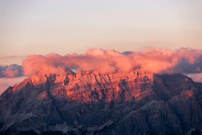 Scenic view of snowcapped mountains against sky during sunset