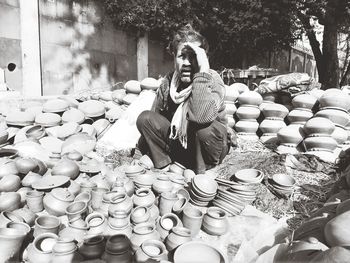 Full length of young woman sitting outdoors