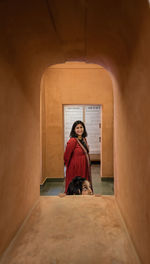 Full length of a woman sitting on cross