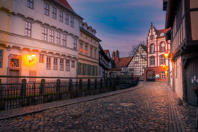 Narrow alloy amidst buildings during sunrise