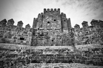 Low angle view of old ruin building against sky