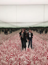 People standing by flowering plants