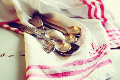High angle view of spoons on napkin at table