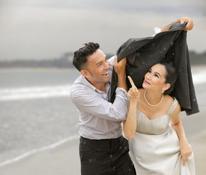 Close-up of bride and groom on beach