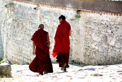 Rear view of people walking in snow