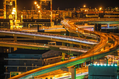 Light trails on bridge in city at night