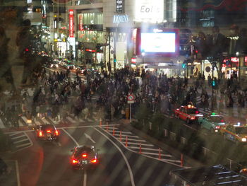 Crowd on road in city at night