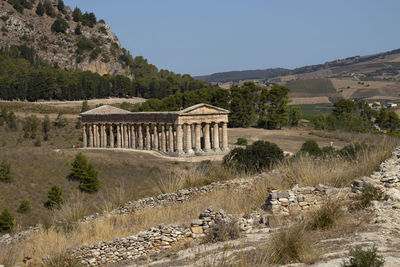 Old temple structure on mountain against sky