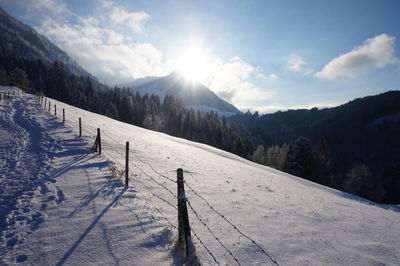 Scenic view of landscape against sky during winter