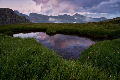 Scenic view of lake and mountains against sky