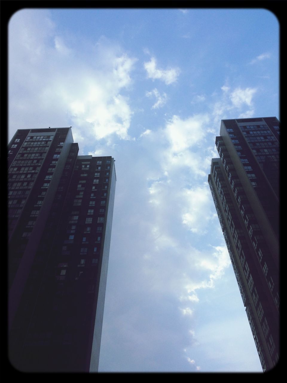 transfer print, building exterior, architecture, built structure, low angle view, sky, auto post production filter, skyscraper, city, modern, office building, cloud - sky, tall - high, building, cloud, tower, tall, day, glass - material, cloudy