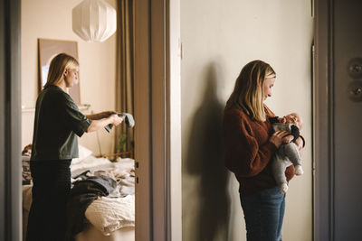 Mothers taking care of newborn baby and doing chores at home